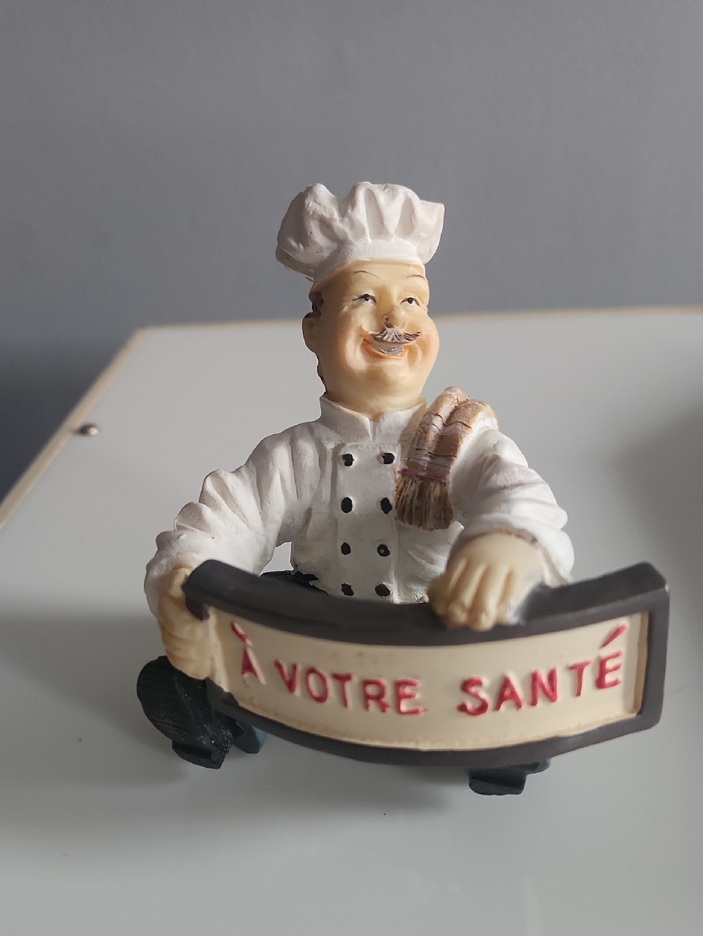 Chef Figurine Holding "À Votre Santé" Sign - White and Cream